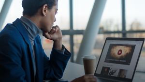 a woman using a website with a video in it.