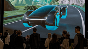 people looking at a 3D model of a car