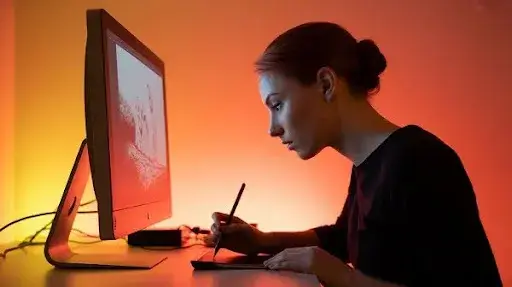 A female animator working on 2D art using modern software technology